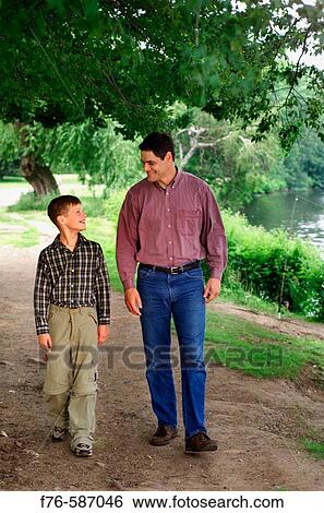 Father and son walking and talking. View Large Photo Image Stock Photograph - Father and son walking and talking.. Fotosearch