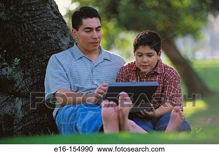 Father and son working on computer View Large Photo Image Stock Image - Father and son working on computer. Fotosearch