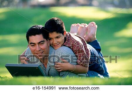 Father and son working on computer View Large Photo Image Stock Image - Father and son working on computer. Fotosearch