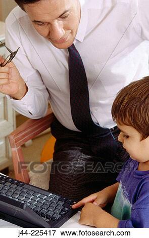 Father and son working with laptop computer View Large Photo Image Stock Photo - Father and son working with laptop computer. Fotosearch