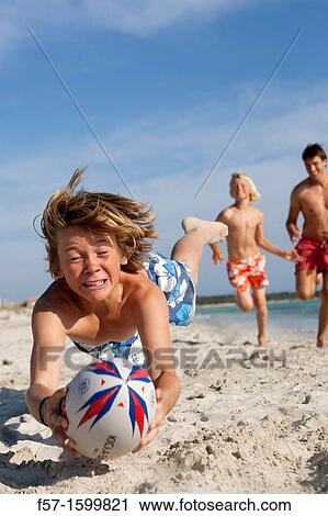 Father and sons playing ball on the beach View Large Photo Image Stock Image - Father and sons playing ball on the beach. Fotosearch