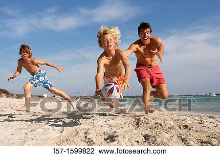 Father and sons playing ball on the beach View Large Photo Image Stock Image - Father and sons playing ball on the beach. Fotosearch