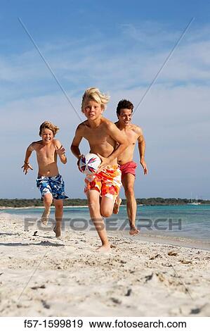 Father and sons playing ball on the beach View Large Photo Image Stock Photo - Father and sons playing ball on the beach. Fotosearch
