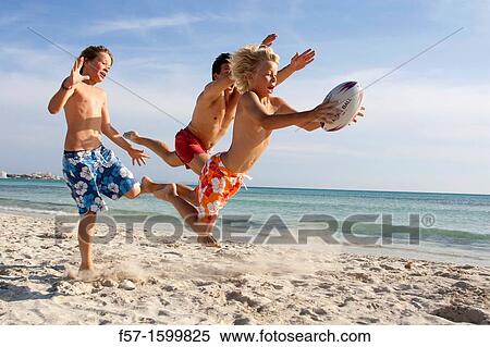 Father and sons playing ball on the beach View Large Photo Image Stock Photography - Father and sons playing ball on the beach. Fotosearch