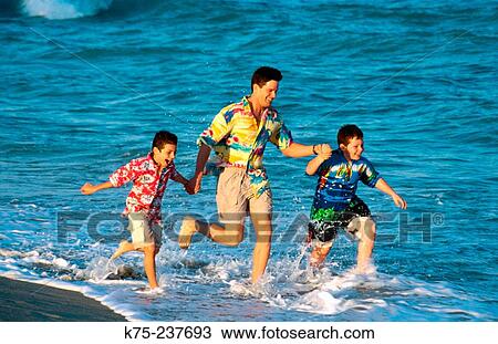 Father and sons running through surf View Large Photo Image Stock Image - Father and sons running through surf. Fotosearch