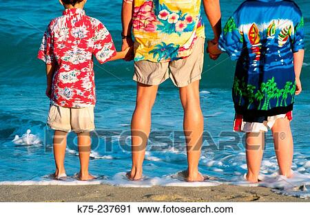 Father and sons watching the surf roll in View Large Photo Image Stock Image - Father and sons watching the surf roll in. Fotosearch