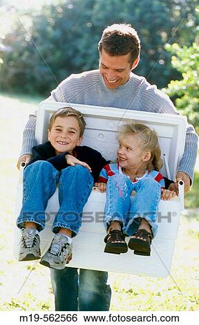 father carrying kids in a cooler View Large Photo Image Stock Photograph - father carrying kids in a cooler. Fotosearch