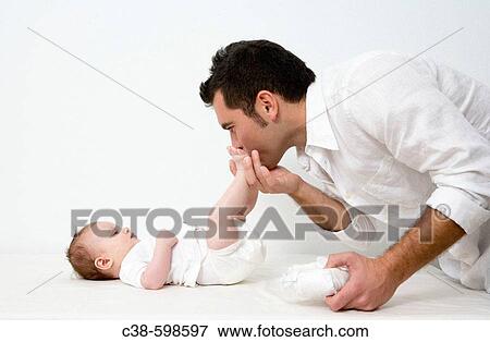Father Changing Nappy on his Baby Girl View Large Photo Image Stock Photo - Father Changing Nappy on his Baby Girl. Fotosearch
