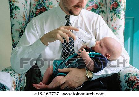 Father feeding baby bottle View Large Photo Image Stock Photo - Father feeding baby bottle. Fotosearch