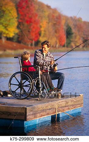 Stock Photo - father fishing with his son in a wheelchair. Fotosearch