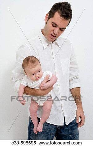 Stock Photography - Father Holding his Baby Girl. Fotosearch
