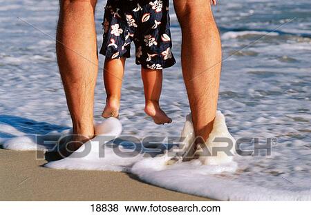 Father holding up son in surf View Large Photo Image Stock Photo - Father holding up son in surf. Fotosearch