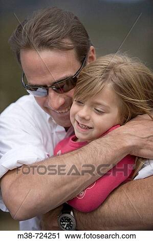 Father hugging daughter, Lone Mt Ranch, Big Sky, Montana, USA View Large Photo Image Stock Image - Father hugging daughter, Lone Mt Ranch, Big Sky, Montana, USA. Fotosearch