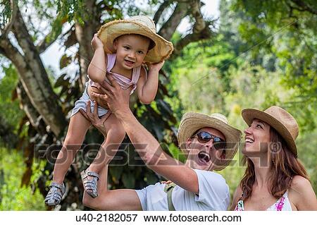 Stock Photo - Father lifting son in the air. Fotosearch
