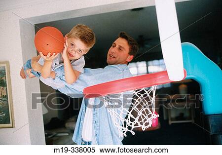 Stock Photography - Father playing basketball with his son. Fotosearch