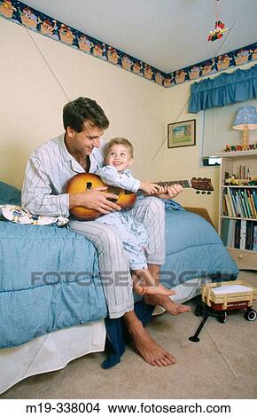 Father playing guitar with his kid View Large Photo Image Picture - Father playing guitar with his kid. Fotosearch