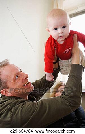 Father playing with his baby View Large Photo Image Picture - Father playing with his baby. Fotosearch