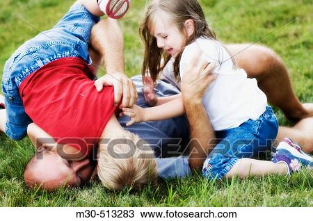 Stock Image - Father playing with his kids.. Fotosearch