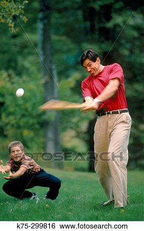 Stock Photograph - father, son playing ball. Fotosearch