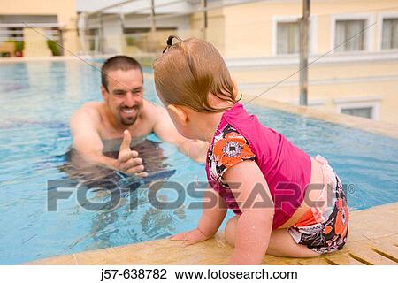Father teaching 16 month old daughter to swim in hotel pool in Athens. Greece. View Large Photo Image Stock Image - Father teaching 16 month old daughter to swim in hotel pool in Athens. Greece.. Fotosearch