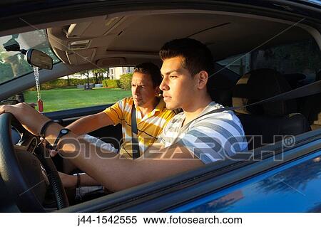 Father teaching son to drive in the street View Large Photo Image Stock Photography - Father teaching son to drive in the street. Fotosearch
