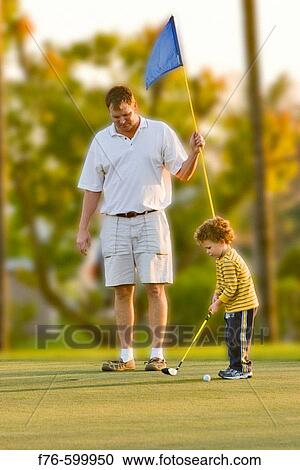 Father teaching son to play golf. Miami. Florida. USA. View Large Photo Image Stock Image - Father teaching son to play golf. Miami. Florida. USA.. Fotosearch