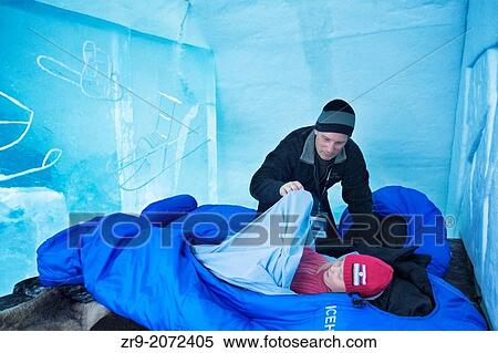 Father tucking his daughter into sleeping bag atop the ice bed, Ice Hotel, Jukkasj? rvi, Kiruna, arctic Sweden View Large Photo Image Stock Photography - Father tucking his daughter into sleeping bag atop the ice bed, Ice Hotel, Jukkasj? rvi, Kiruna, arctic Sweden. Fotosearch