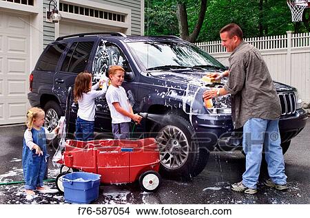 Picture - Father washing his car with his children helping.. Fotosearch