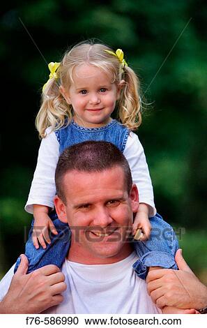 Father with daughter sitting on his shoulders. View Large Photo Image Stock Image - Father with daughter sitting on his shoulders.. Fotosearch