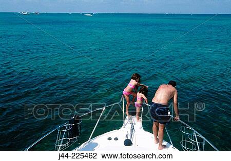 Father with daughters standing on boat's prow View Large Photo Image Stock Image - Father with daughters standing on boat's prow. Fotosearch