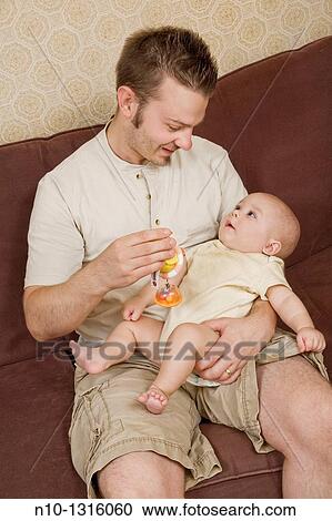 Stock Image - Father with his six-month old son. Fotosearch