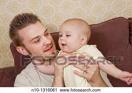 Father with his six-month old son View Large Photo Image Stock Image - Father with his six-month old son. Fotosearch