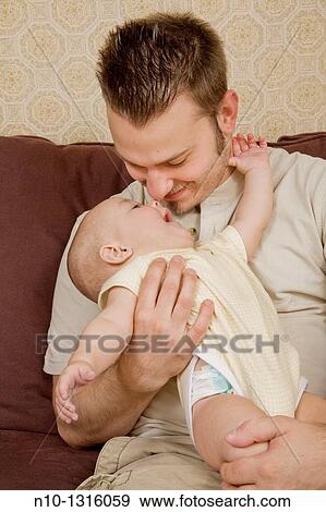 Stock Photo - Father with his six-month old son. Fotosearch