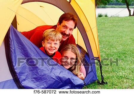 Father with son and daughter, looking out from tent, camping. View Large Photo Image Stock Image - Father with son and daughter, looking out from tent, camping.. Fotosearch