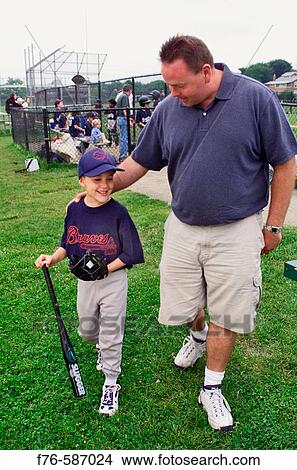 Father with son at little league baseball game. View Large Photo Image Picture - Father with son at little league baseball game.. Fotosearch