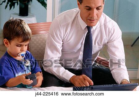 Father with son working with laptop computer in bedroom View Large Photo Image Stock Photograph - Father with son working with laptop computer in bedroom. Fotosearch