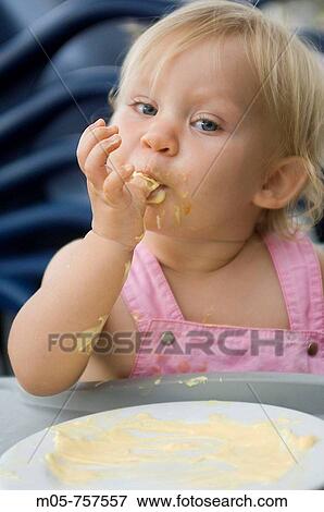 Stock Photo - Feeding toddler of 15 month old. Fotosearch