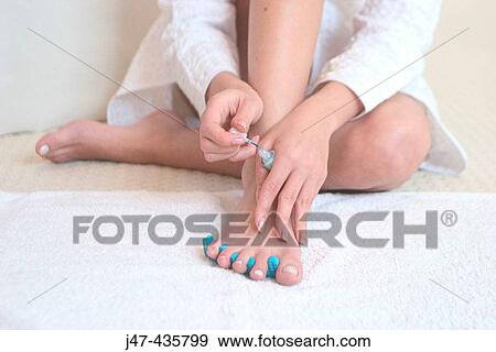 feet and hands of a girl applying nail varnish View Large Photo Image Stock Photo - feet and hands of a girl applying nail varnish. Fotosearch