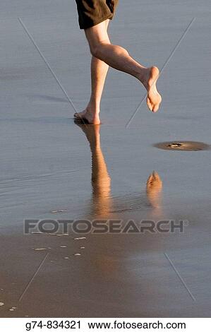Feet and reflection of a jogger on the California beach View Large Photo Image Stock Image - Feet and reflection of a jogger on the California beach. Fotosearch