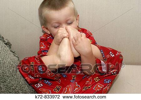 Feet and toes can be a fascinating subject to a toddler View Large Photo Image Stock Image - Feet and toes can be a fascinating subject to a toddler. Fotosearch