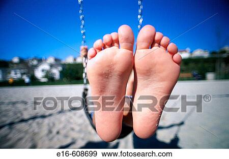 Feet in swing View Large Photo Image Stock Photo - Feet in swing. Fotosearch