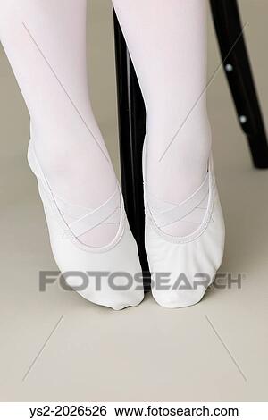 Feet of ballerina wearing white ballet slippers. View Large Photo Image Stock Photograph - Feet of ballerina wearing white ballet slippers.. Fotosearch