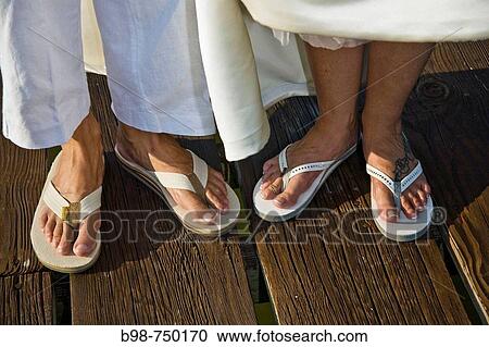 Stock Image - Feet wearing sandals. Fotosearch