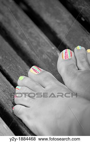 Feet with decorated nails over wooden slats View Large Photo Image Stock Photo - Feet with decorated nails over wooden slats. Fotosearch