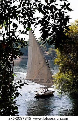 Felucca sailing in the Nile - Aswan, Upper Egypt. View Large Photo Image Stock Photography - Felucca sailing in the Nile - Aswan, Upper Egypt.. Fotosearch
