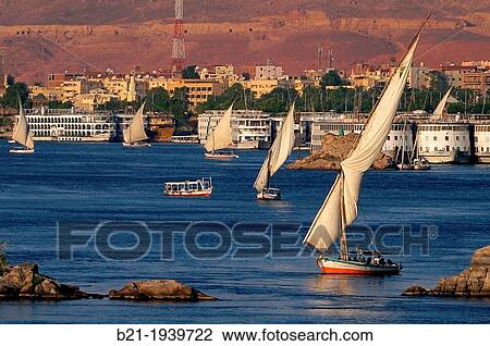 ? Feluccas? and Nile's hotel boats on the Nile river at Aswan, Egypt View Large Photo Image Stock Image - ? Feluccas? and Nile's hotel boats on the Nile river at Aswan, Egypt. Fotosearch