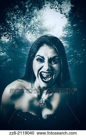 Stock Image - Femaile vampire in the woods.. Fotosearch