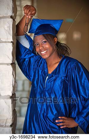 Picture - Female African American Student Portrait in Graduation Outfit on College Campus. Fotosearch