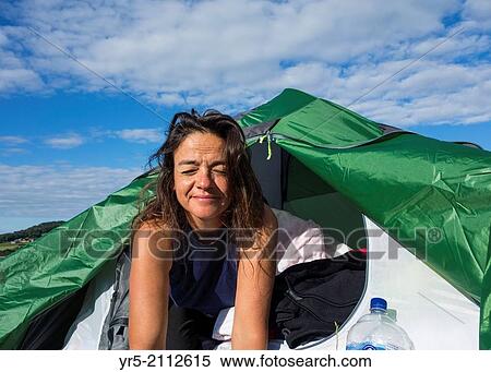 Female camper waking up on a bright summer`s day on campsite at Robin Hoods Bay, North Yorkshire, England, United Kingdom. View Large Photo Image Stock Photography - Female camper waking up on a bright summer`s day on campsite at Robin Hoods Bay, North Yorkshire, England, United Kingdom.. Fotosearch