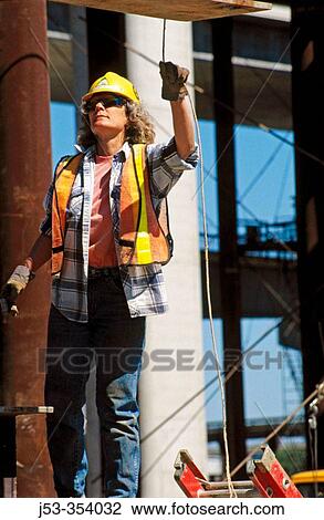 Stock Image - Female construction worker. I-880 Cypress project. Oakland, California. USA.. Fotosearch